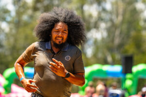 Man with long curly hair running