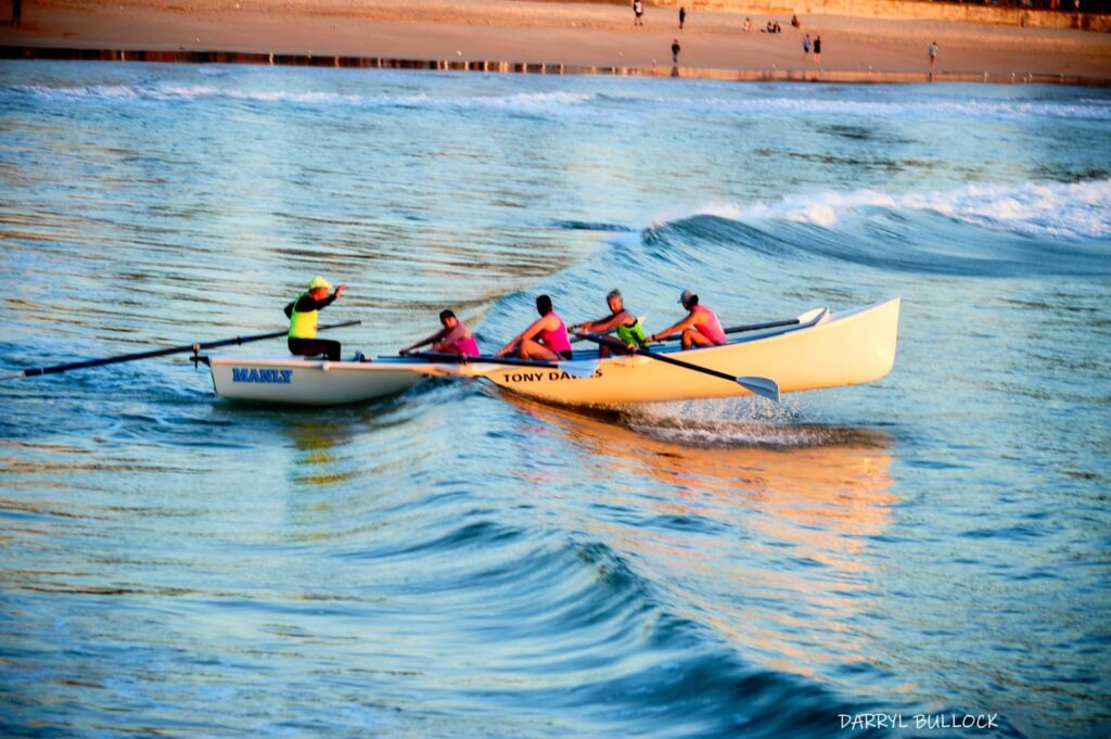 Surfboat at dawn headed out to sea